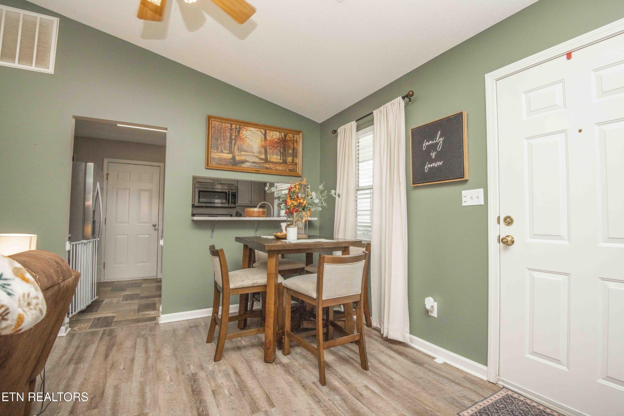 7533 Gary White Road Corryton, TN 37721 - Photo 8 of 44 a view of a dining room with furniture and wooden floor