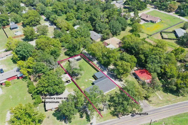an aerial view of a house with a yard and outdoor seating