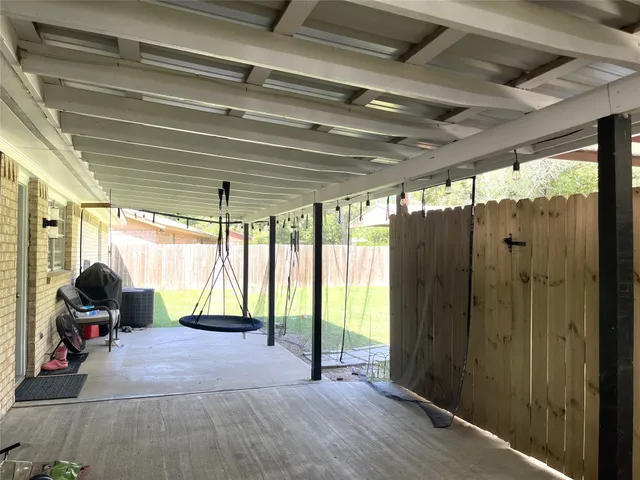 a gym room with large windows and furniture