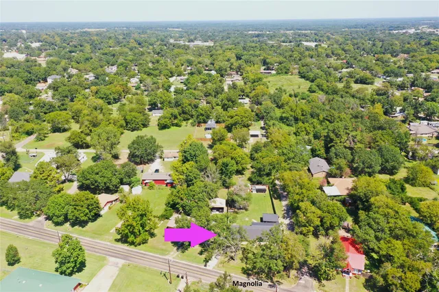 an aerial view of residential houses with cars
