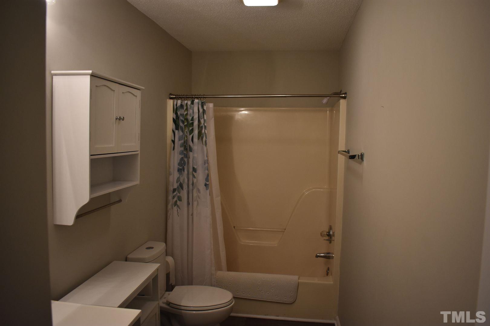 614 Mc Kay Street Erwin, NC 28339 - Photo 13 of 24 a bathroom with a shower a toilet and a shower