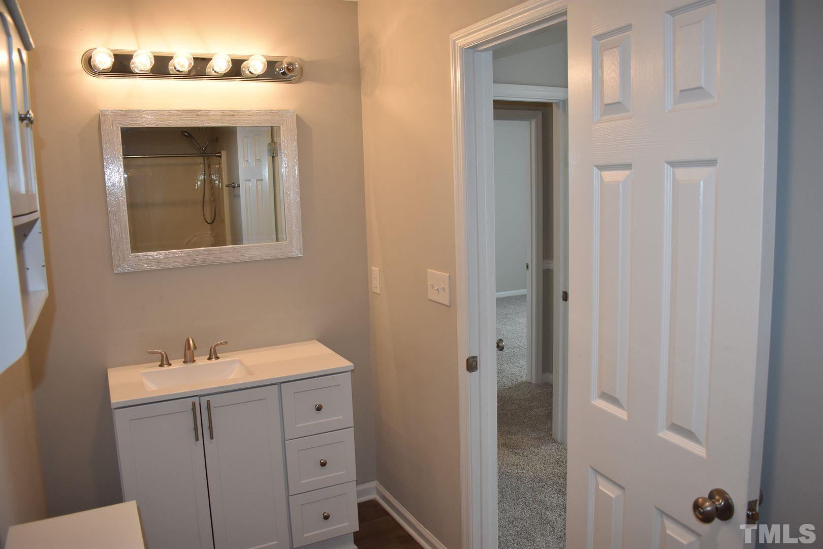 614 Mc Kay Street Erwin, NC 28339 - Photo 18 of 24 a bathroom with a sink and a mirror