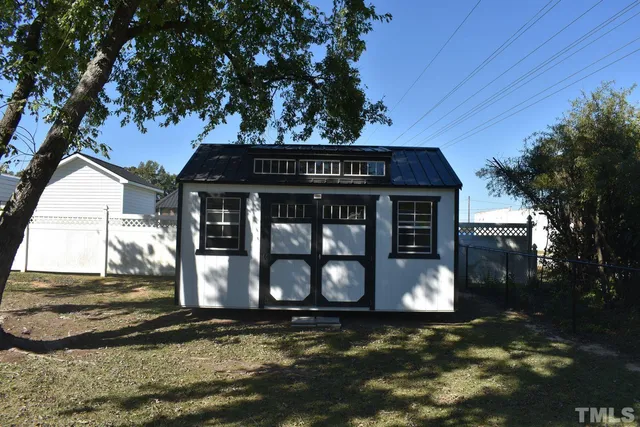 a view of a house with a tree and a yard