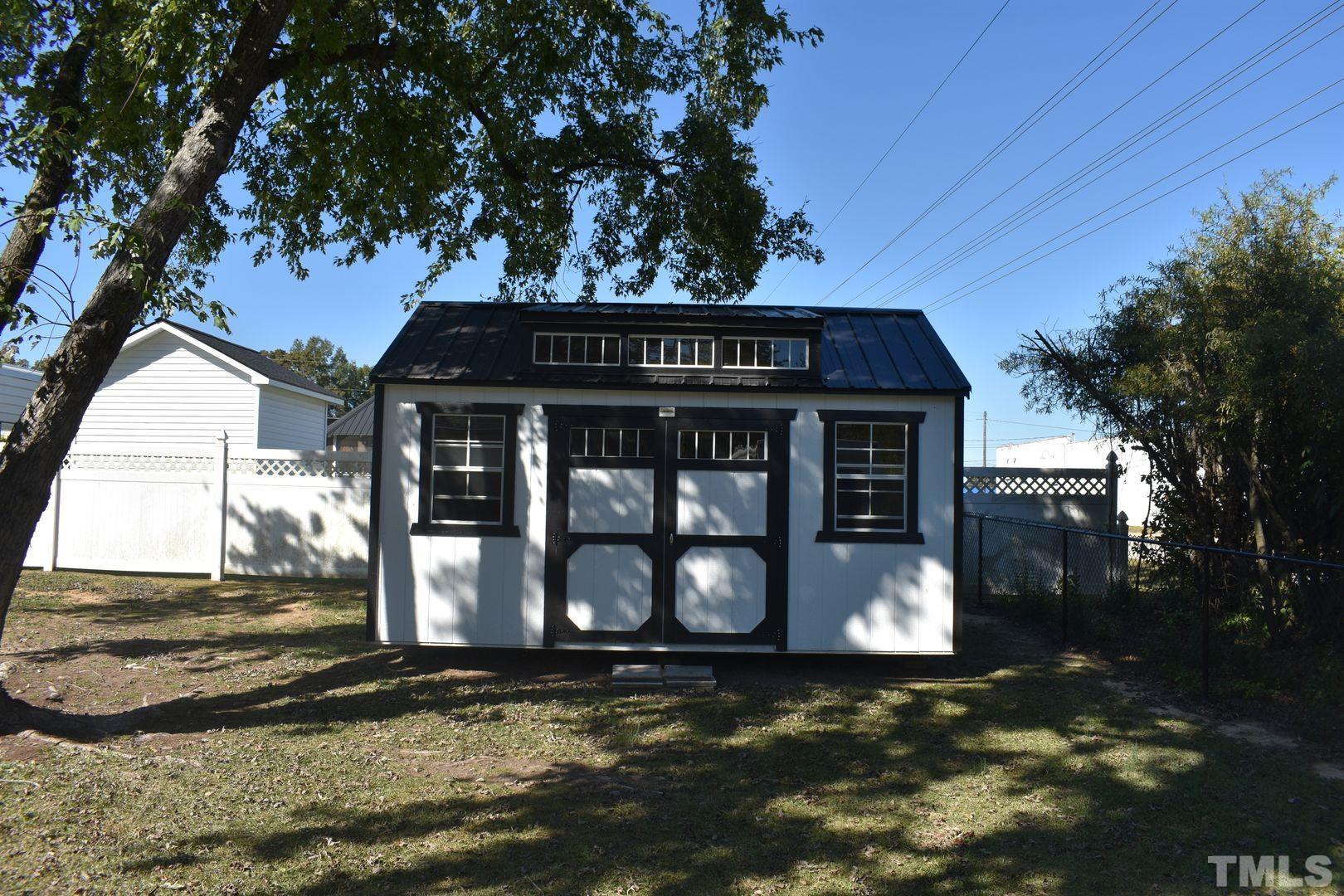 614 Mc Kay Street Erwin, NC 28339 - Photo 23 of 24 a view of a house with a tree and a yard
