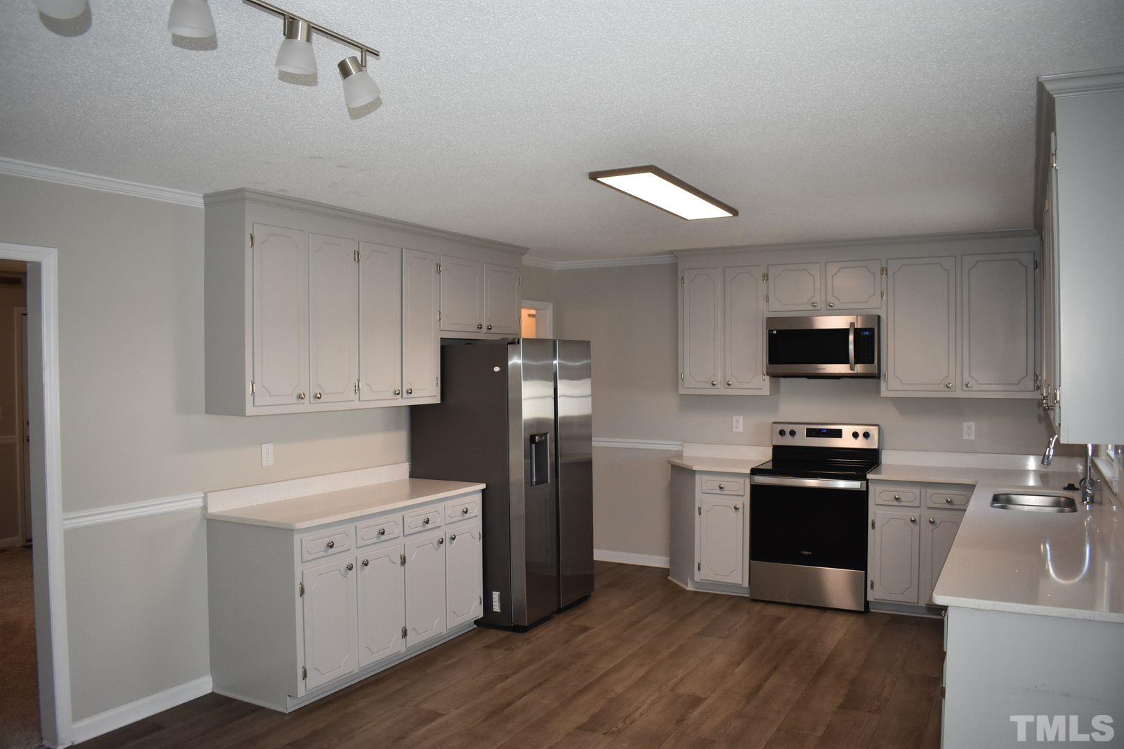 614 Mc Kay Street Erwin, NC 28339 - Photo 7 of 24 a kitchen with stainless steel appliances a refrigerator stove and sink