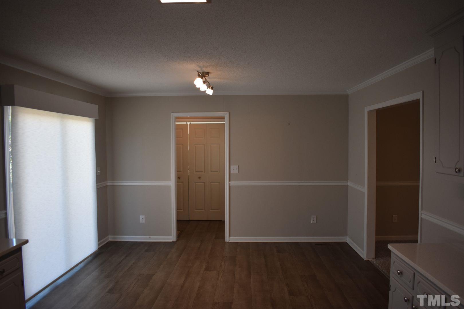 614 Mc Kay Street Erwin, NC 28339 - Photo 8 of 24 an empty room with wooden floor and windows