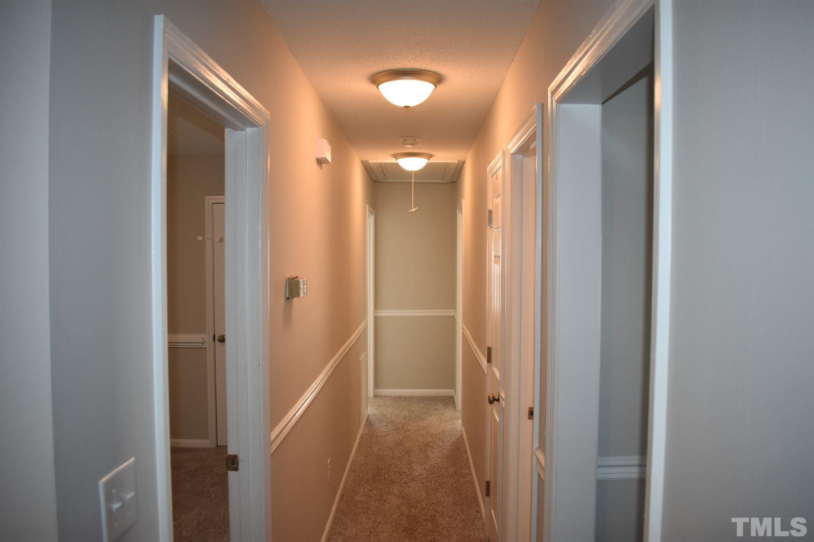 614 Mc Kay Street Erwin, NC 28339 - Photo 10 of 24 a view of a hallway with wooden floor and a bathroom