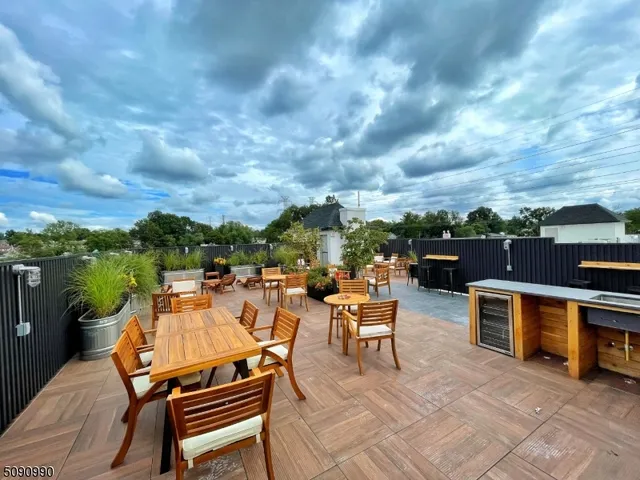 a view of a terrace with furniture and a stove