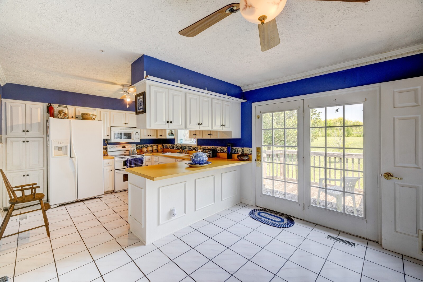 7486 Deer Ridge Road Primm Springs, TN 38476 - Photo 26 of 69 a kitchen with white cabinets and window