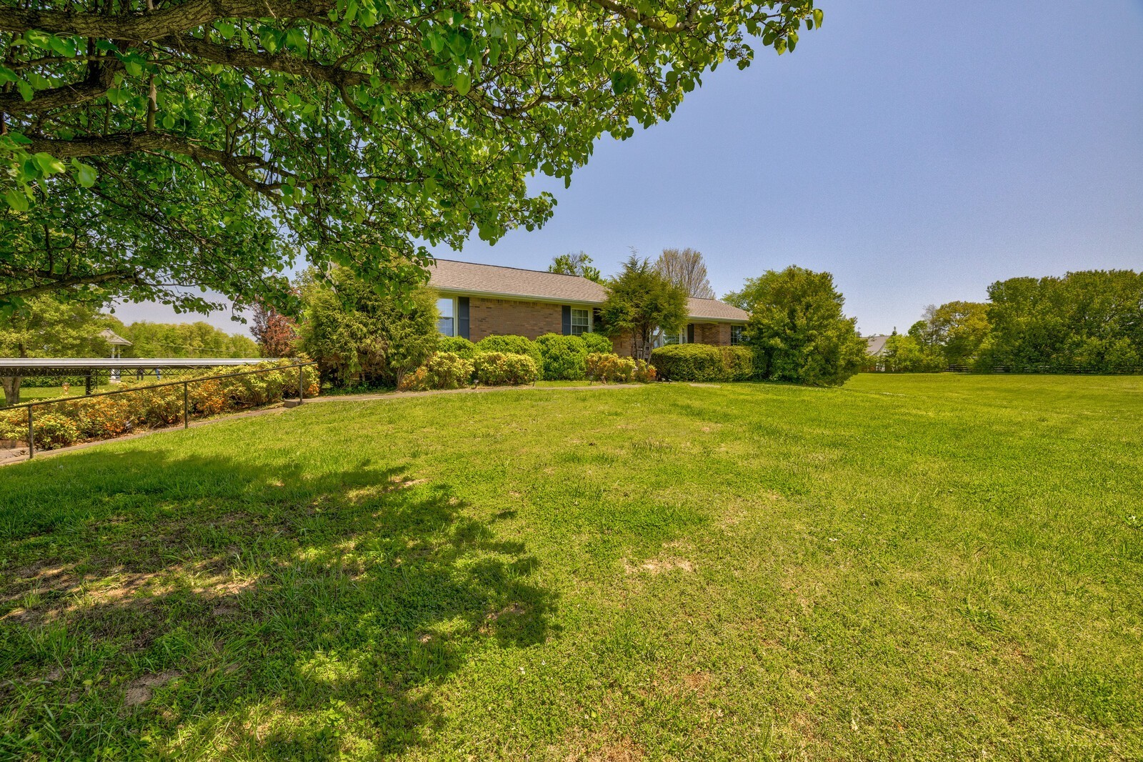 7486 Deer Ridge Road Primm Springs, TN 38476 - Photo 5 of 69 a view of a garden with a building in the background