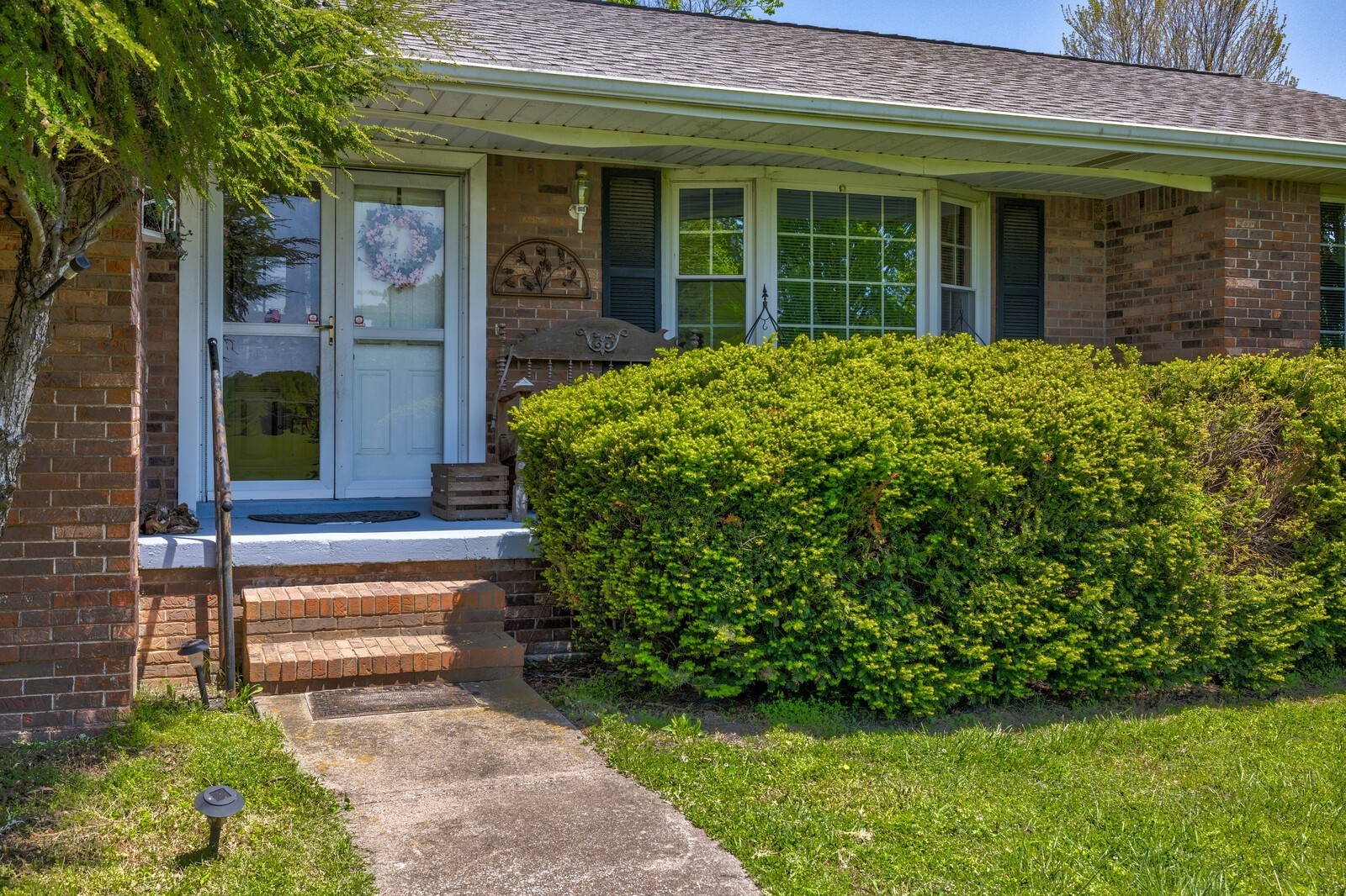 7486 Deer Ridge Road Primm Springs, TN 38476 - Photo 7 of 69 a view of a house with potted plants and a large window