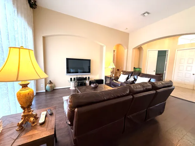 a living room with furniture and floor to ceiling windows