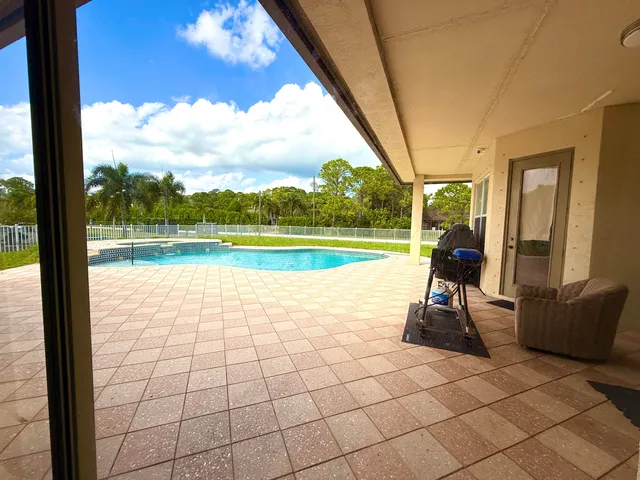 a view of yard with swimming pool and green space