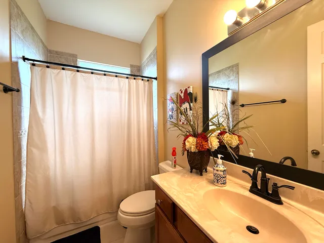 a living room with furniture and a view of kitchen
