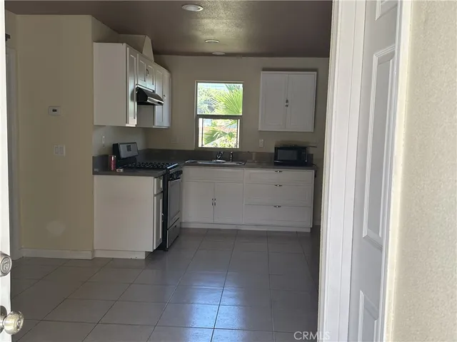 a kitchen with a stove a sink and a refrigerator