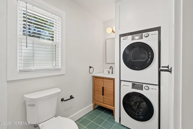 a utility room with dryer washer and a window