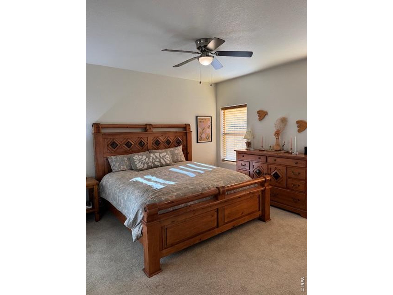 2865 Big Thunder Road Berthoud, CO 80513 - Photo 22 of 35 a bedroom with a bed and a ceiling fan