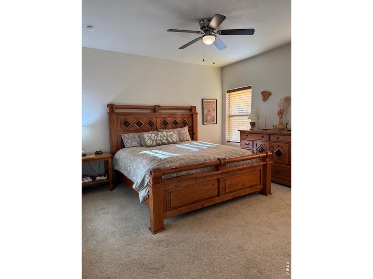 2865 Big Thunder Road Berthoud, CO 80513 - Photo 25 of 35 a large bedroom with a bed and a chandelier