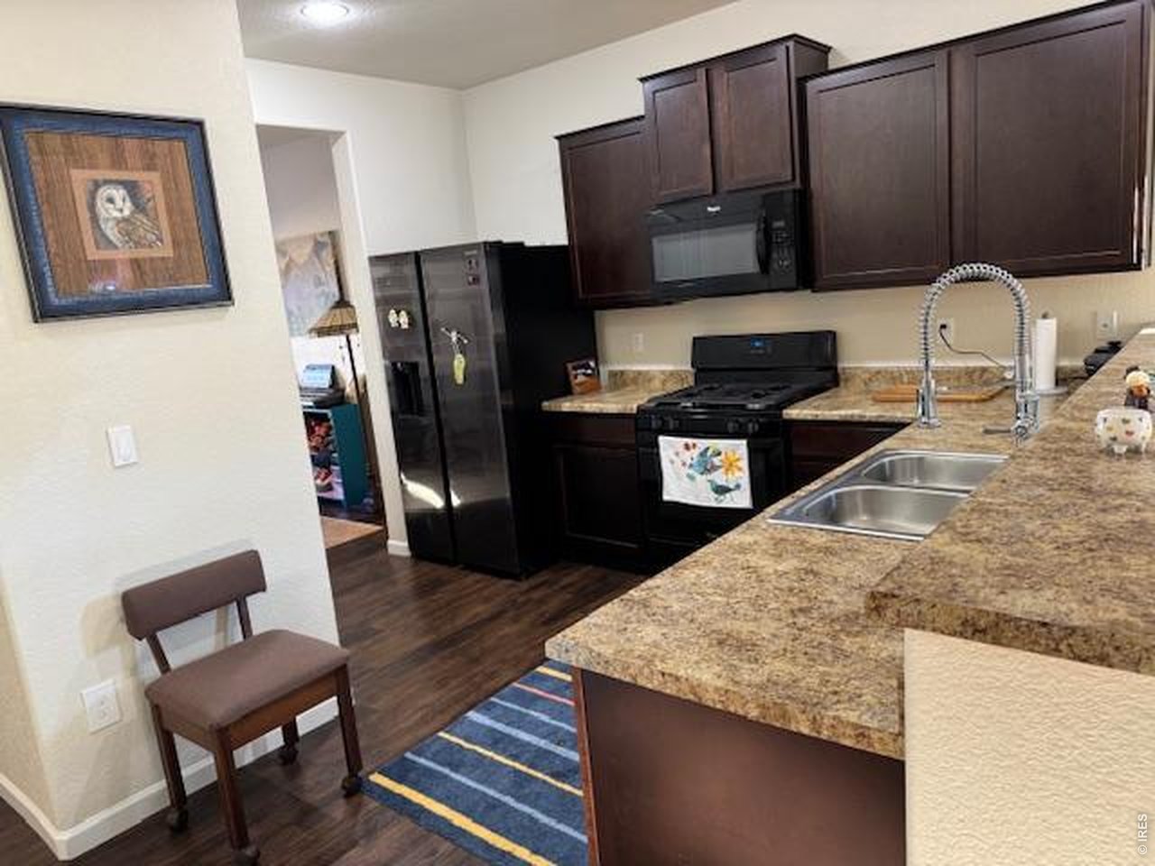2865 Big Thunder Road Berthoud, CO 80513 - Photo 8 of 35 a kitchen with stainless steel appliances granite countertop a refrigerator a stove and a sink with wooden cabinets