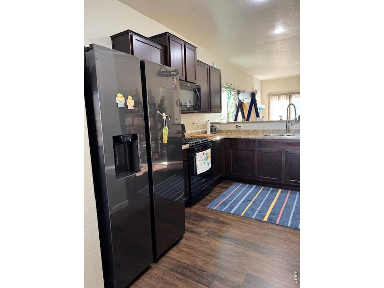 2865 Big Thunder Road Berthoud, CO 80513 - Photo 9 of 35 a kitchen with stainless steel appliances granite countertop a refrigerator and a stove