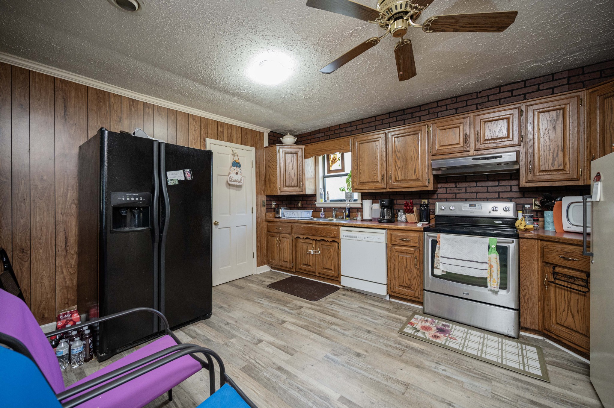 145 Crenshaw Road Bethpage, TN 37022 - Photo 12 of 44 a kitchen with granite countertop stainless steel appliances and wooden cabinets