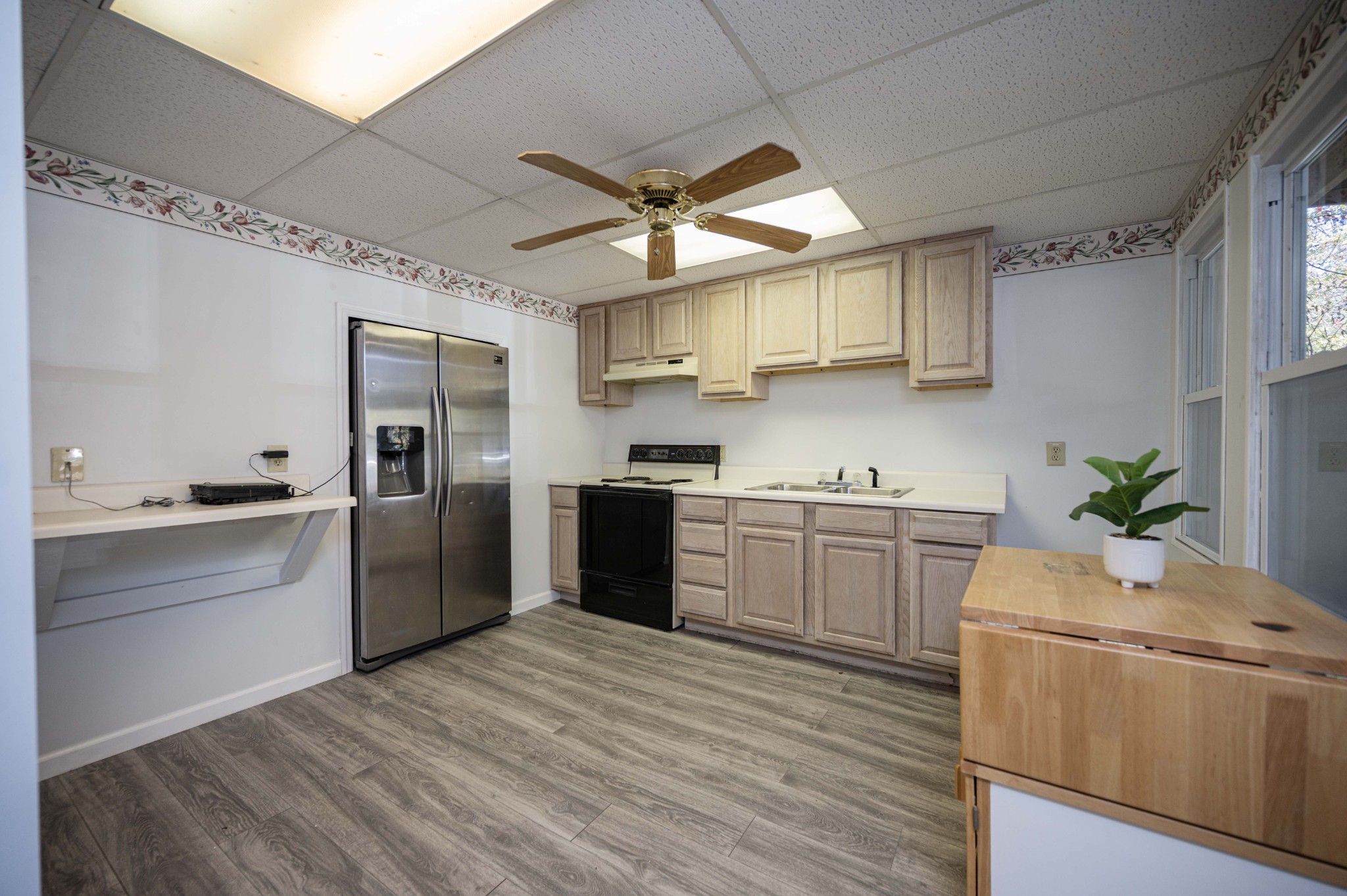 145 Crenshaw Road Bethpage, TN 37022 - Photo 19 of 44 a kitchen with a refrigerator sink cabinets and wooden floor