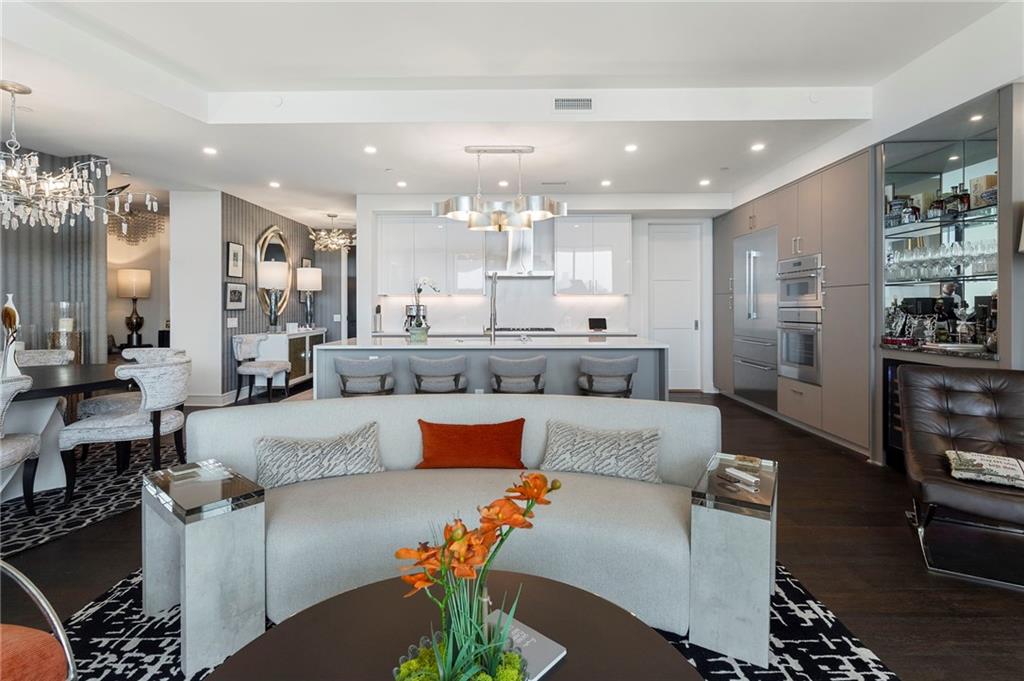 2425 Peachtree Street Northeast, Unit 707 Atlanta, GA 30305 - Photo 13 of 39 a large living room with stainless steel appliances kitchen island granite countertop furniture and a view of kitchen
