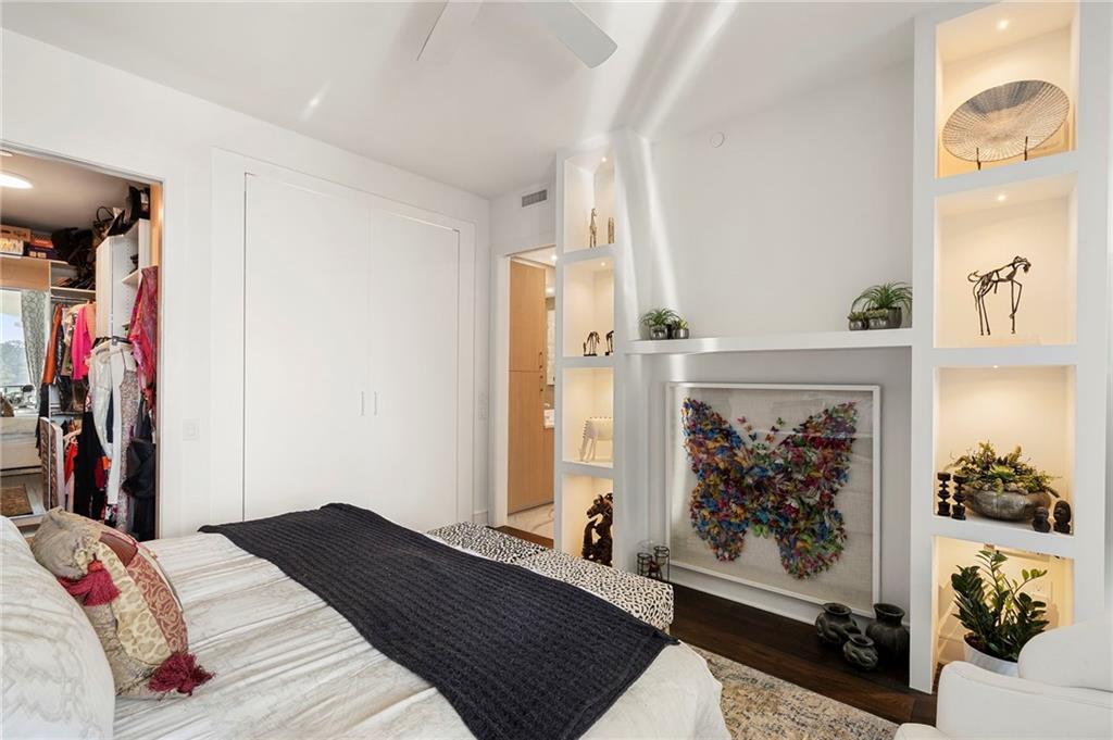 2425 Peachtree Street Northeast, Unit 707 Atlanta, GA 30305 - Photo 20 of 39 a bedroom with a bed and a fireplace