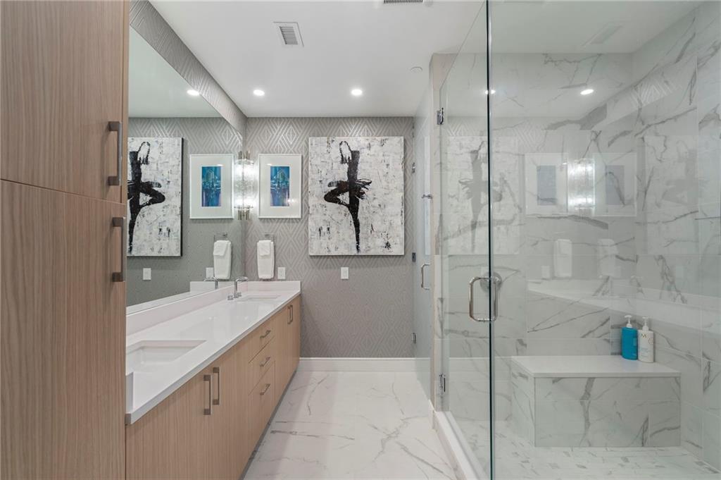 2425 Peachtree Street Northeast, Unit 707 Atlanta, GA 30305 - Photo 21 of 39 a bathroom with a granite countertop sink mirror and shower