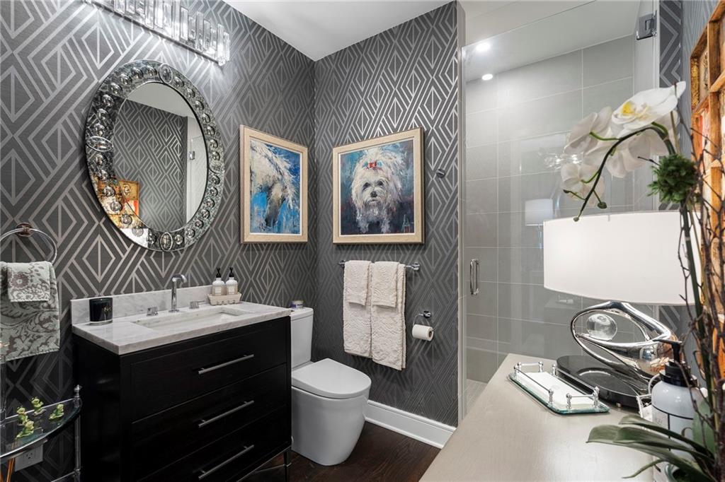2425 Peachtree Street Northeast, Unit 707 Atlanta, GA 30305 - Photo 25 of 39 a bathroom with a toilet sink and mirror