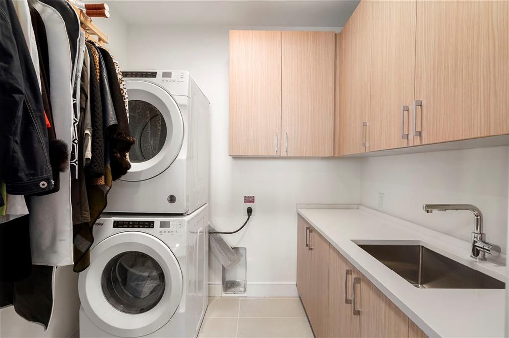 2425 Peachtree Street Northeast, Unit 707 Atlanta, GA 30305 - Photo 26 of 39 a utility room with sink dryer and washer