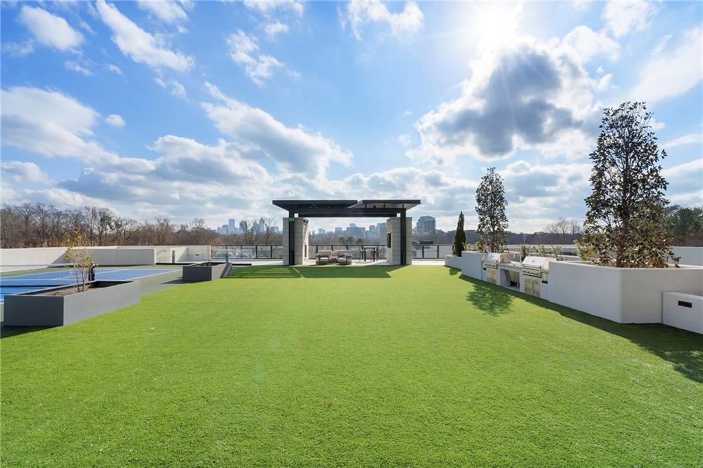 2425 Peachtree Street Northeast, Unit 707 Atlanta, GA 30305 - Photo 33 of 39 a swimming pool with outdoor seating and deck