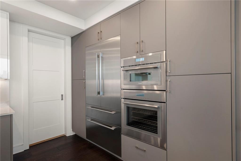2425 Peachtree Street Northeast, Unit 707 Atlanta, GA 30305 - Photo 7 of 39 a kitchen with a refrigerator and cabinets