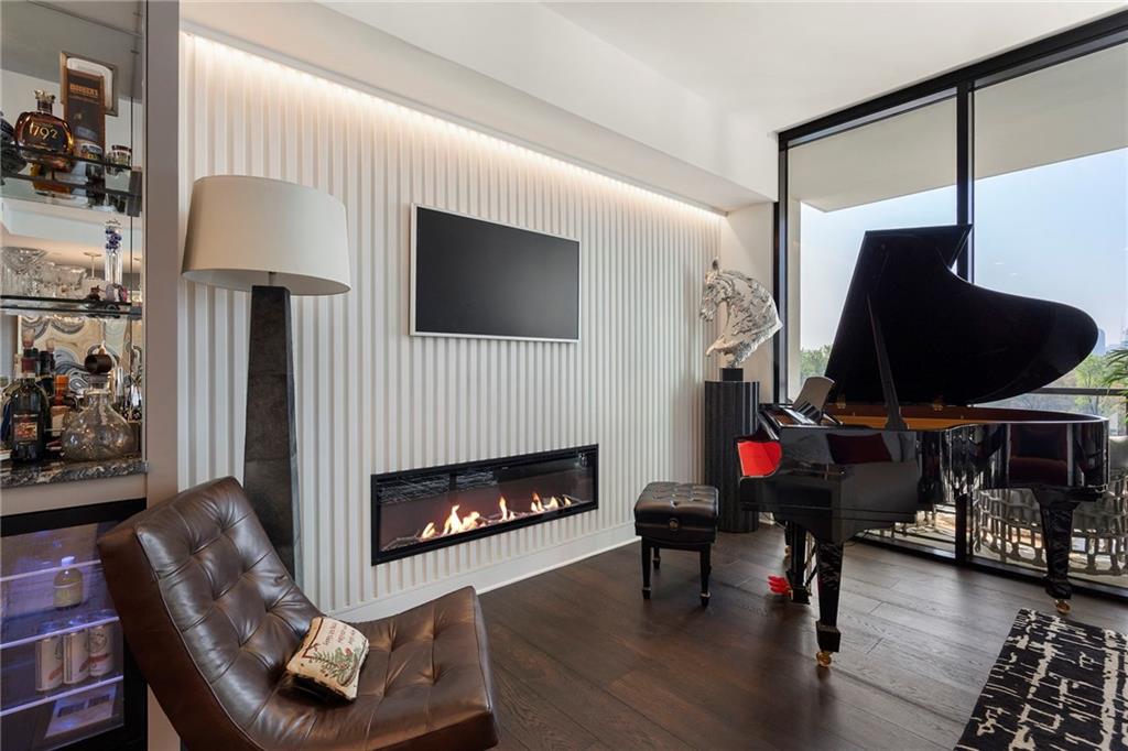 2425 Peachtree Street Northeast, Unit 707 Atlanta, GA 30305 - Photo 10 of 39 a living room with furniture and a fireplace