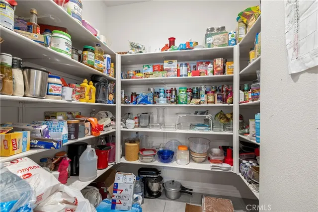a living room with furniture a rug a table and a large window
