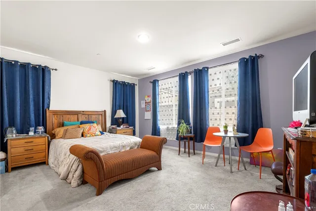 a bedroom with bed and a table