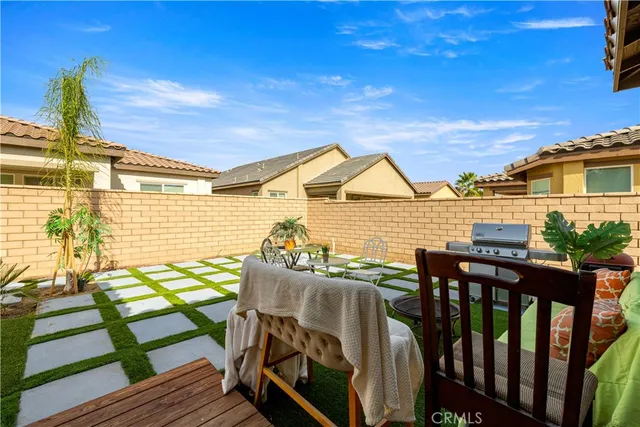 a view of a patio with couches table and chairs and potted plants