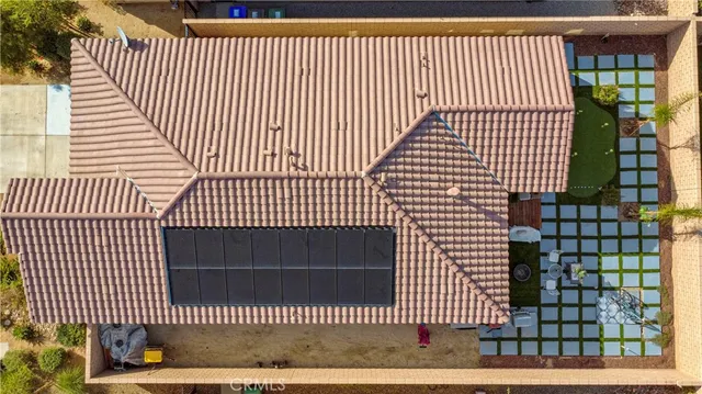 an aerial view of residential houses with outdoor space and parking