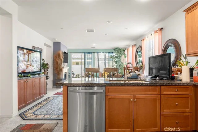 a kitchen with granite countertop a refrigerator and a sink