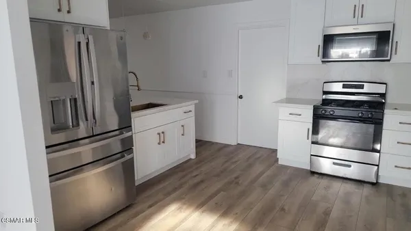 a kitchen with cabinets and steel stainless steel appliances
