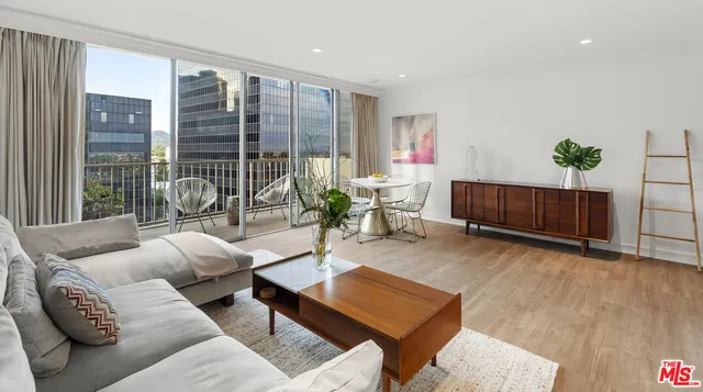 a living room with furniture a lamp and a large window