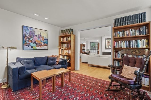 a living room with furniture and a book shelf