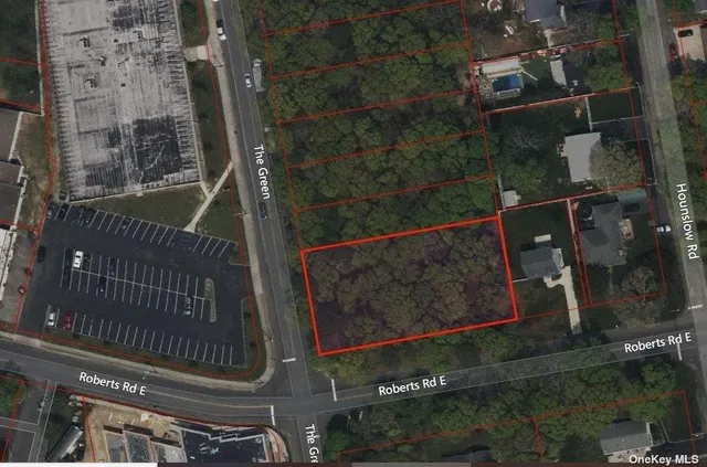 a view of a brick wall with a tree in front