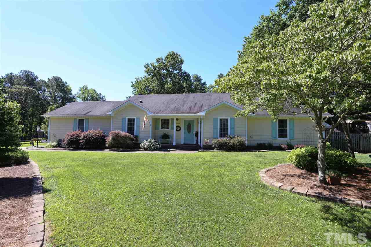 1809 Albacore Lane Raleigh, NC 27612 - Photo 1 of 25 a front view of a house with a yard and garage