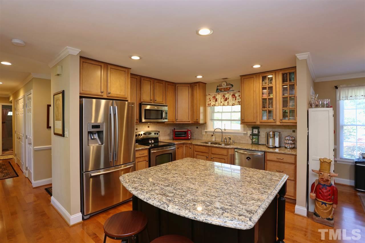 1809 Albacore Lane Raleigh, NC 27612 - Photo 2 of 25 a kitchen with stainless steel appliances granite countertop a refrigerator stove microwave and sink
