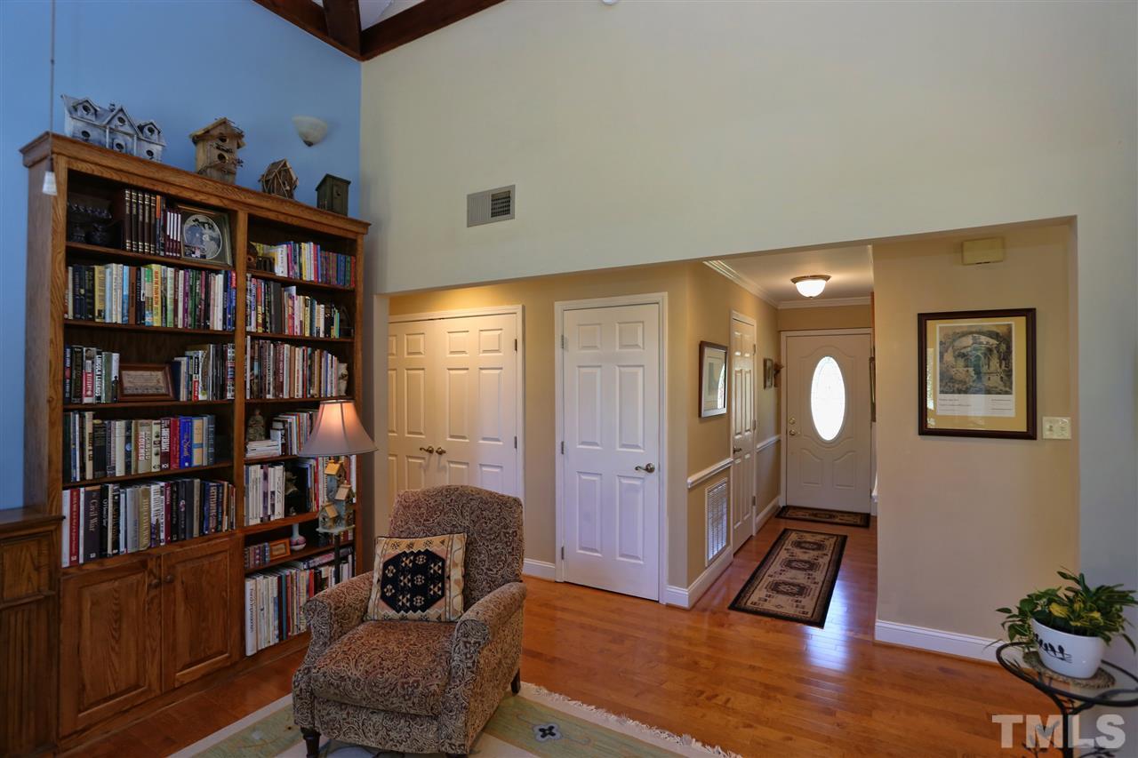 1809 Albacore Lane Raleigh, NC 27612 - Photo 11 of 25 a living room with furniture and a book shelf