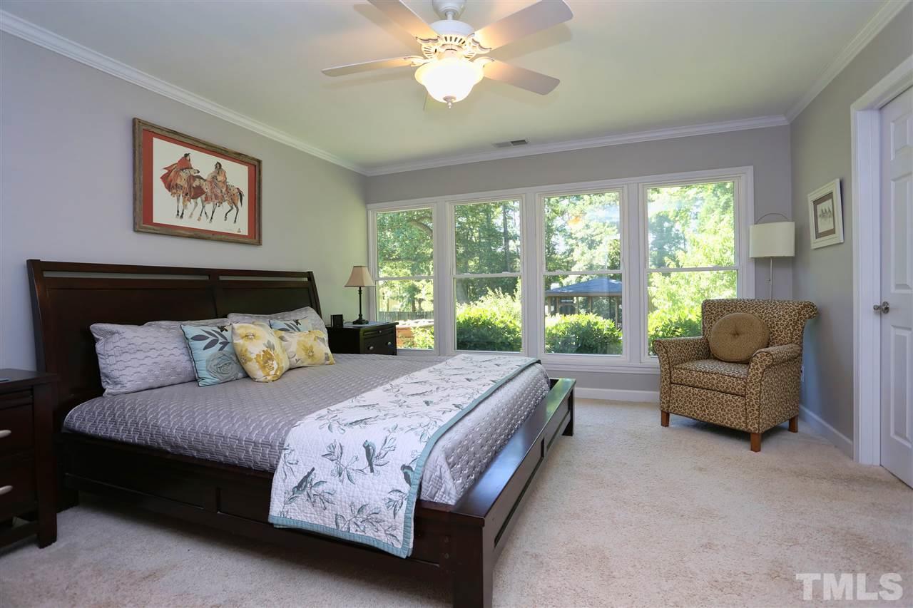 1809 Albacore Lane Raleigh, NC 27612 - Photo 12 of 25 a bedroom with a bed and a couch next to a window