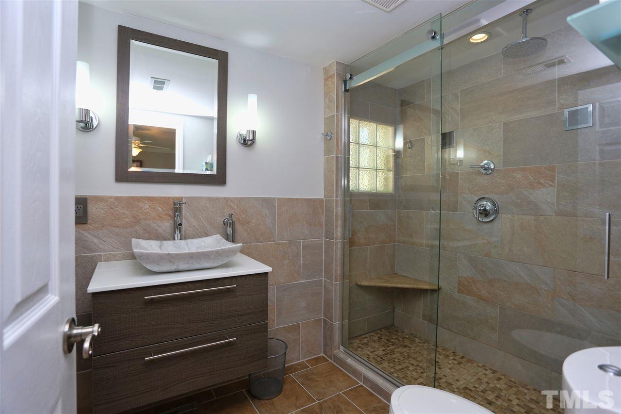 1809 Albacore Lane Raleigh, NC 27612 - Photo 13 of 25 a bathroom with a sink toilet a mirror and shower