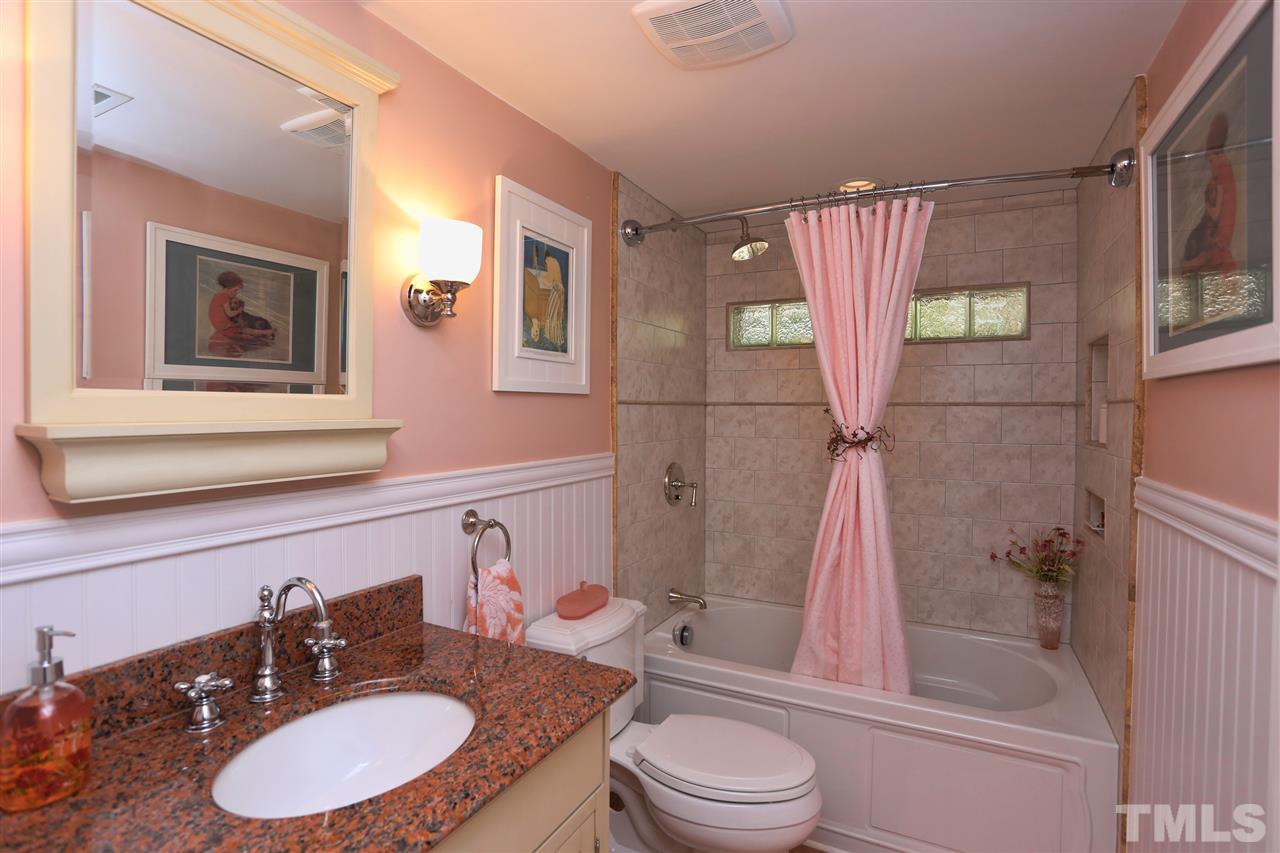 1809 Albacore Lane Raleigh, NC 27612 - Photo 15 of 25 a bathroom with a sink toilet a mirror and shower