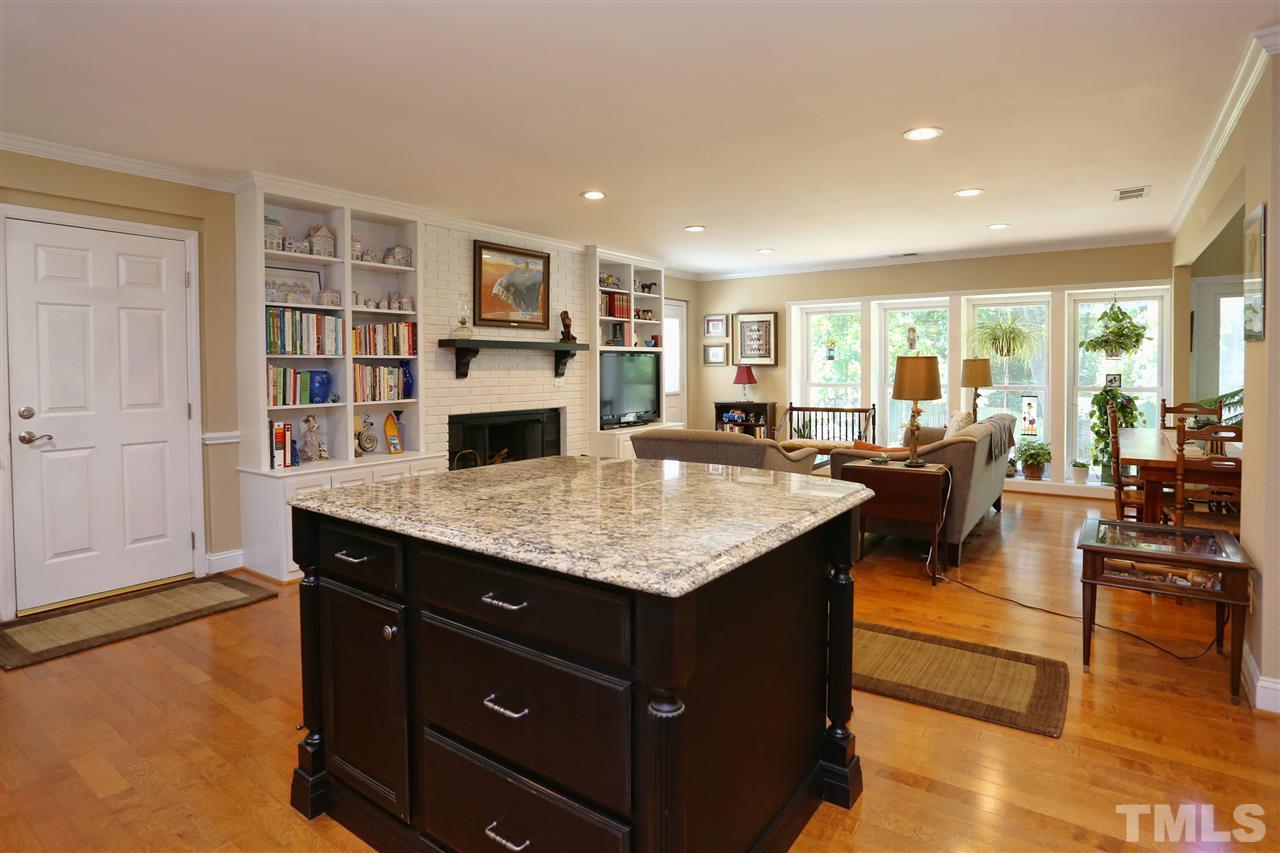 1809 Albacore Lane Raleigh, NC 27612 - Photo 4 of 25 a living room with stainless steel appliances granite countertop a kitchen island a stove and a living room